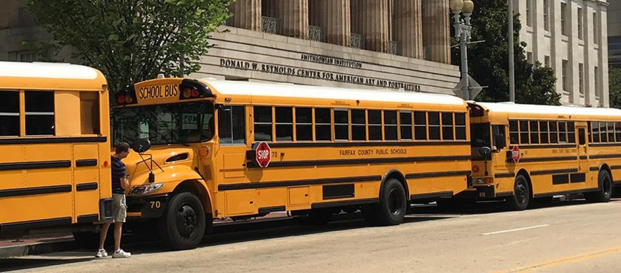 school bus in front of a museum