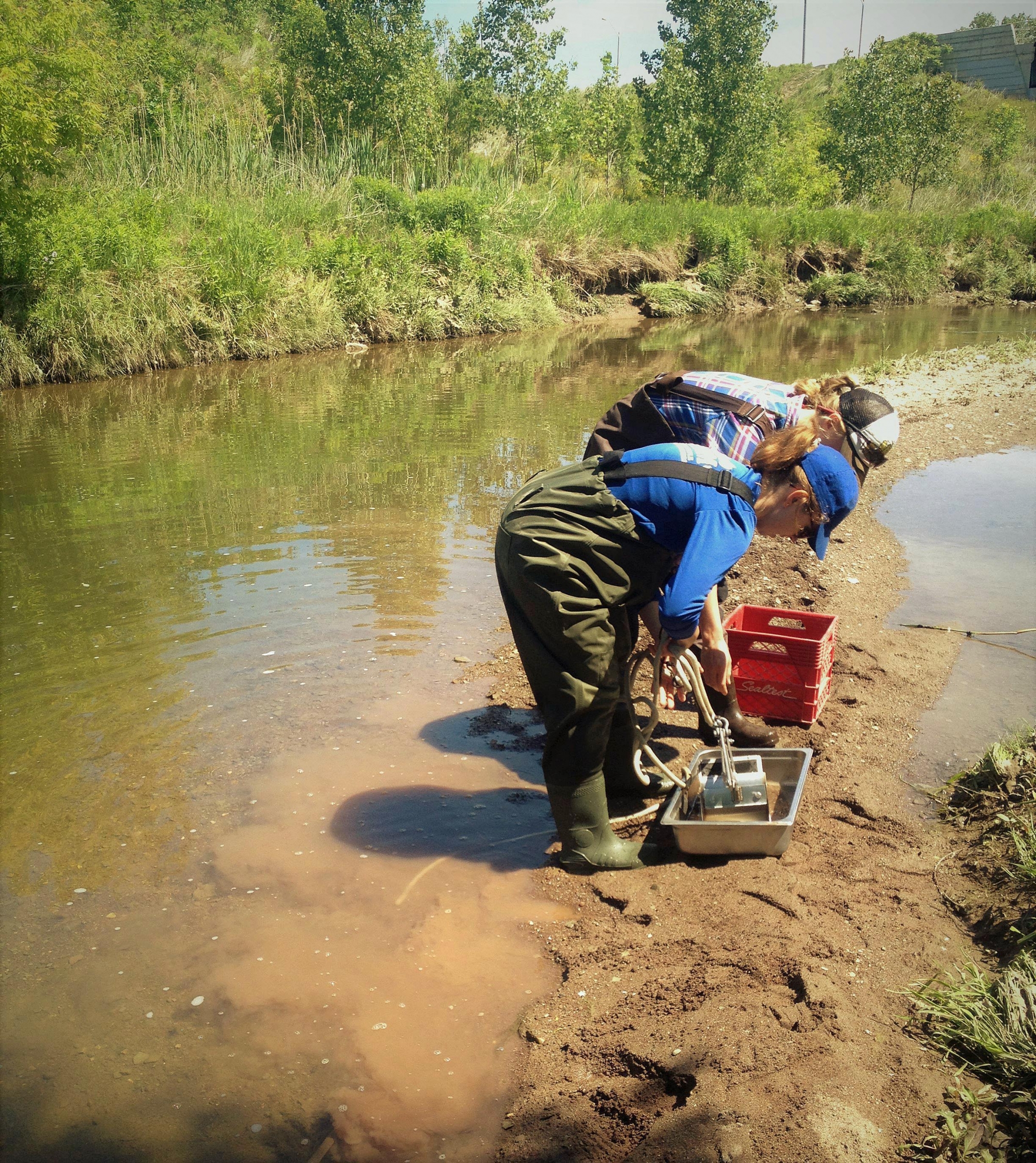 two women collecting water samples