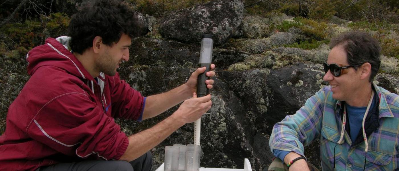 Two people crouching with testing equipment