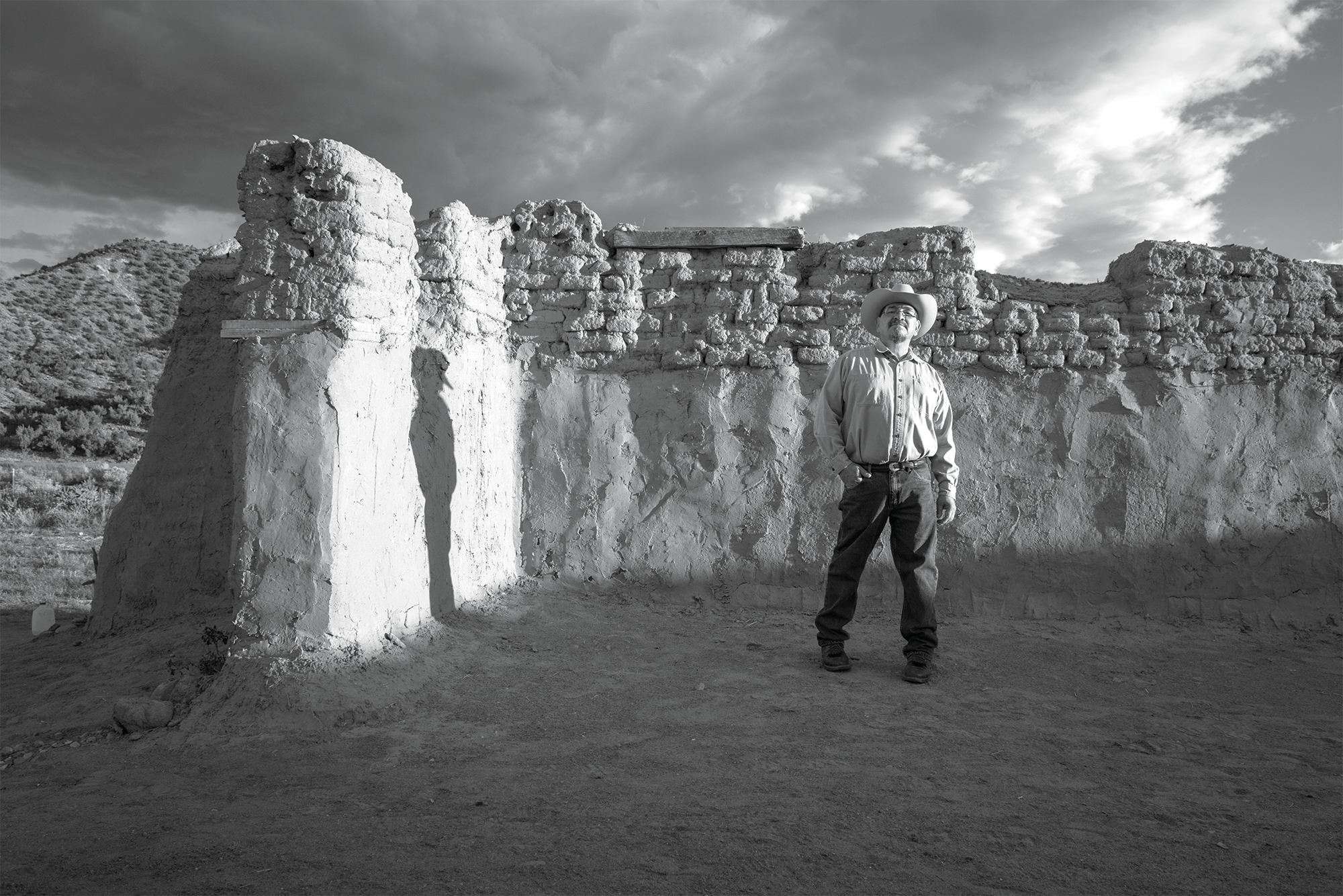 IMAGE Russel Albert Daniels, Genízaro Delvin Garcia standing in remains of the 18th-century Santa Rosa de Lima Church, Abiquiú, New Mexico, 2019 © Russel Albert Daniels.