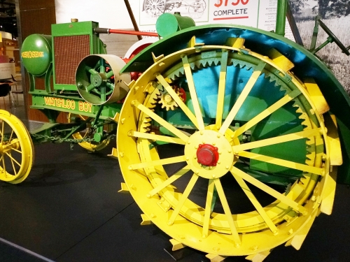 green tractor with large yellow spoked wheels