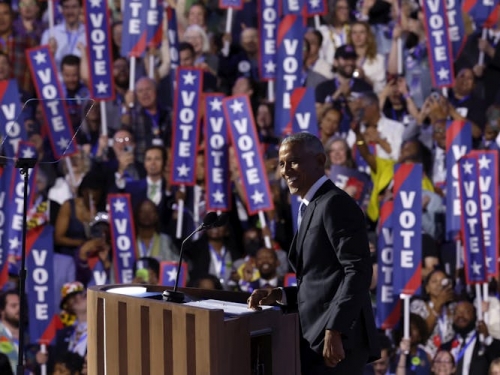 Obama at the DNC with vertical signs