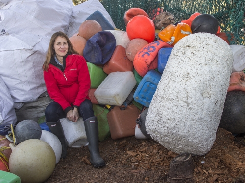 women surrounded by plastic trash 