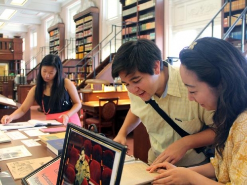 young adults researching books and imagery