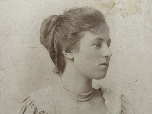 Black and white photograph of a young woman with her hair up.