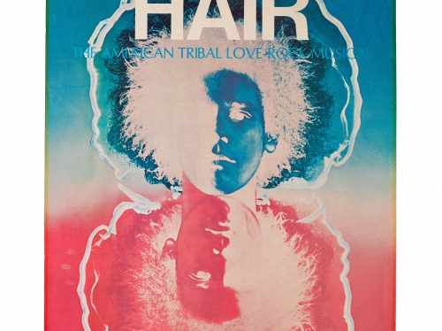 Stylized theater poster with word HAIR across top and mirrored image of person with afro in blue and red.