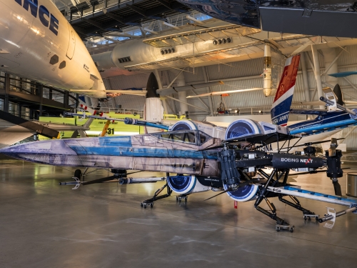 Image of a drone with split wings, in gray and blue paint.