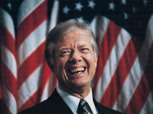 Jimmy Carter in front of American flags