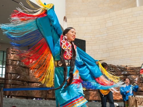 Fancy shawl dancer in colorful native clothing.