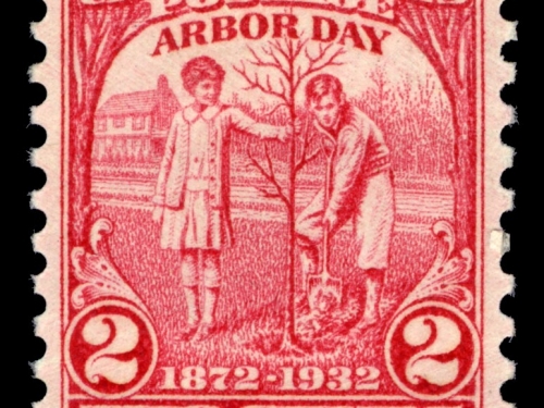 A red and white stamp celebrating Arbor Day.