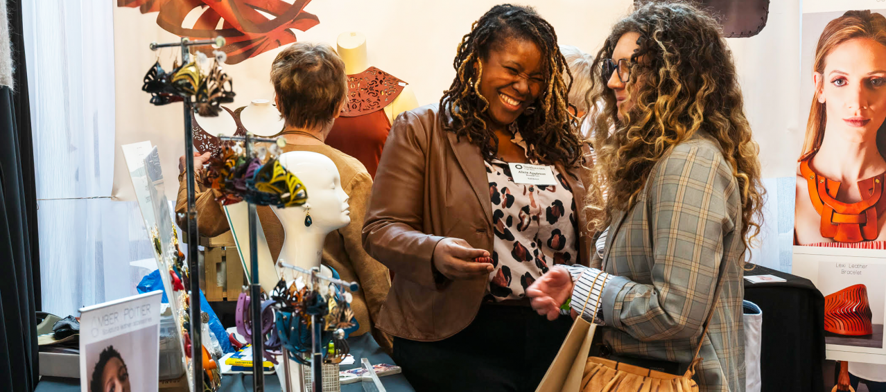 two women standing near table at the craft show hosted by the Smithsonian Women's Committee