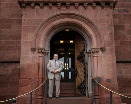 Lonnie Bunch stands at east door of Castle