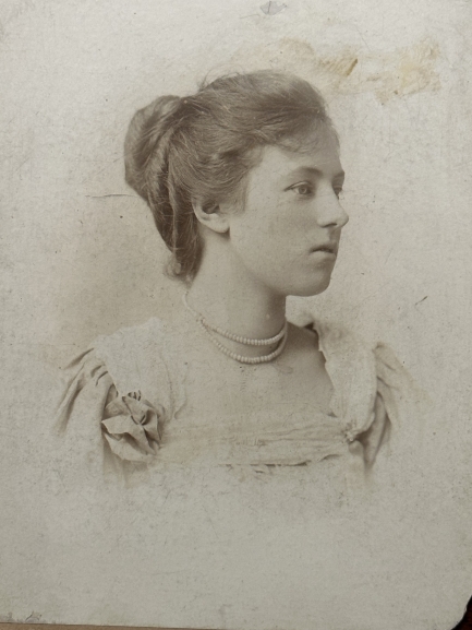 Black and white photograph of a young woman with her hair up.